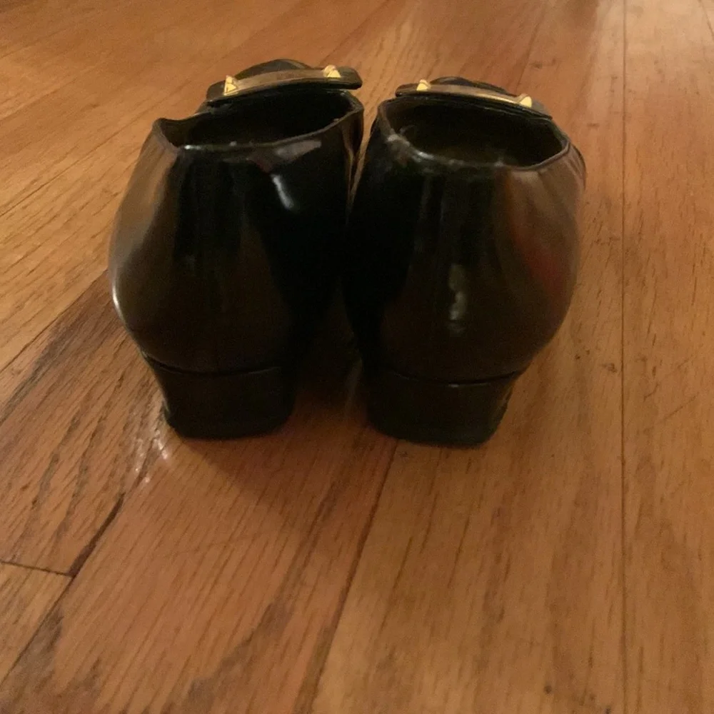 Stuart Weitzman black patent leather loafers with gold plaques and low heel 6